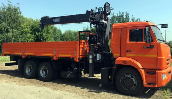 Фото Бортовой КАМАЗ 65117 с тросовым КМУ HORYONG HRS 216